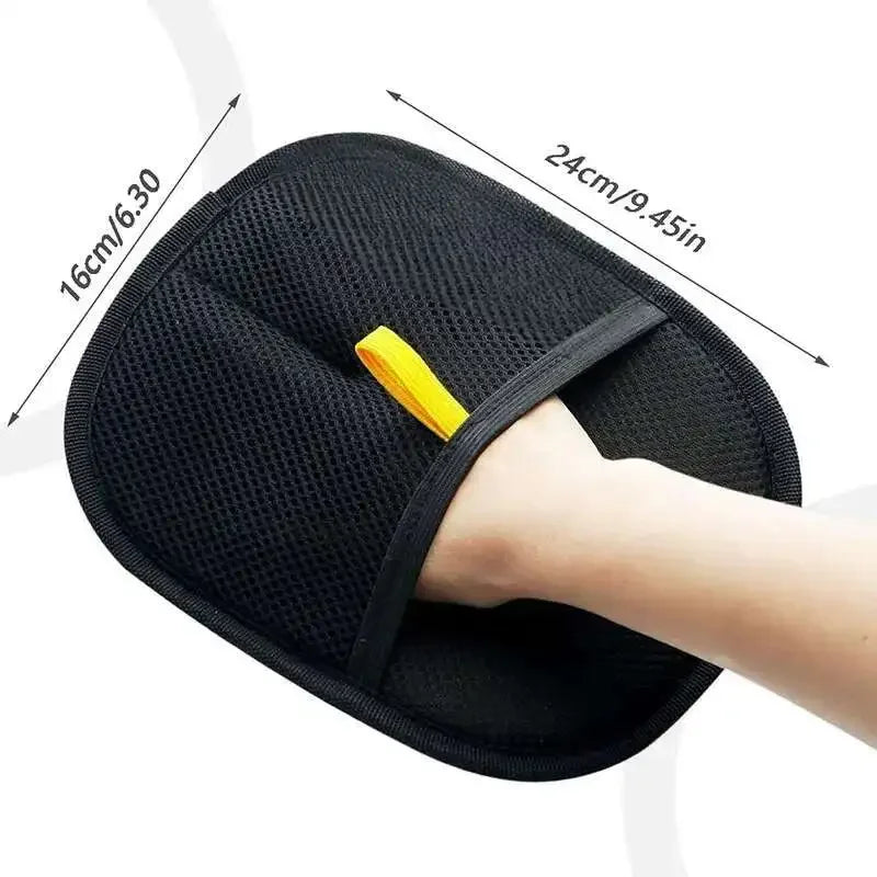 Black reusable pet grooming gloves with yellow accents shown on a hand.