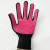 A pink silicone pet massage cleaning glove with a black wrist cuff and textured fingertips.