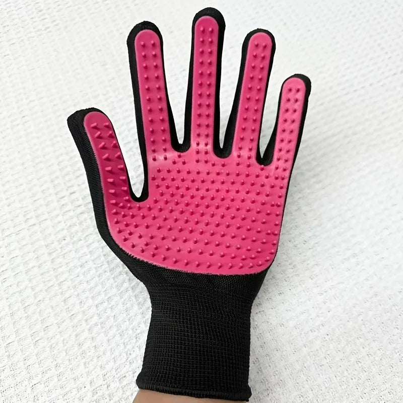 A pink silicone pet massage cleaning glove with a black wrist cuff and textured fingertips.
