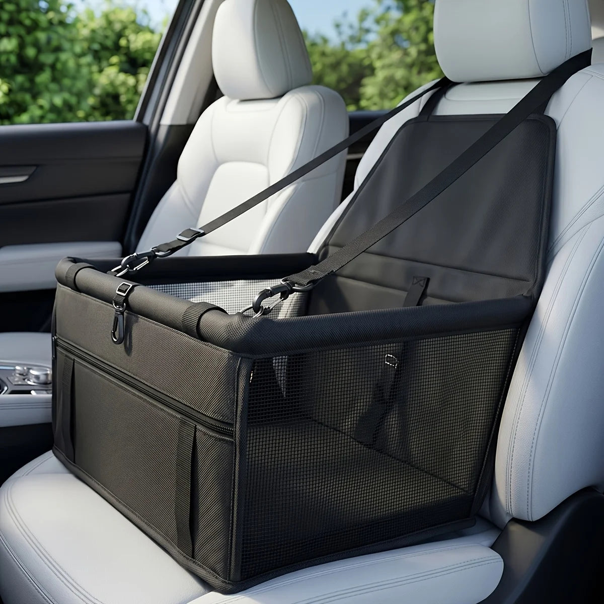 A black portable dog car seat travel carrier with adjustable safety straps placed on a white car seat.