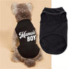 A black pet vest with white text reading Mama's Boy is shown next to a gray fluffy dog.