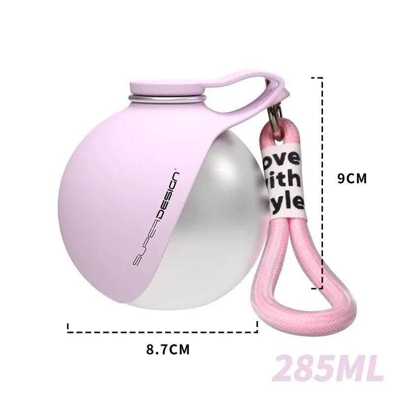 A pink portable stainless steel dog water dispenser with a handle and measuring markings.