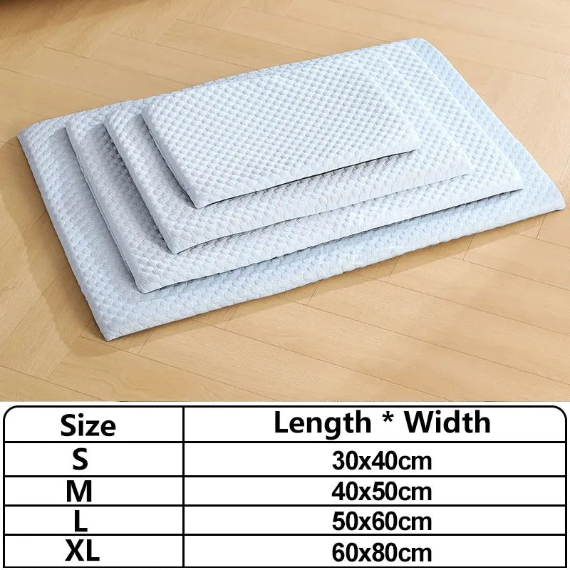 A stack of light blue ice silk cooling pet mats in various sizes S, M, L, and XL are displayed on a wooden surface.