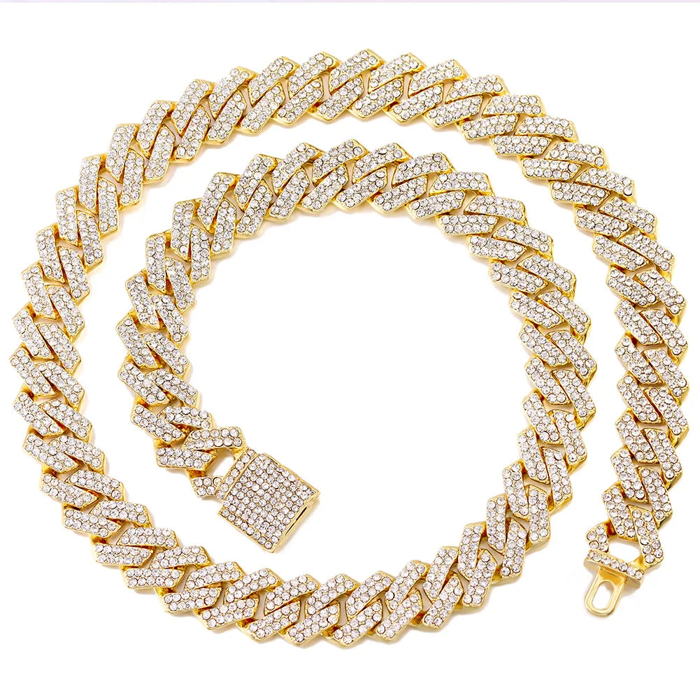 A gold iced out Cuban link chain necklace featuring rhombus diamond accents.