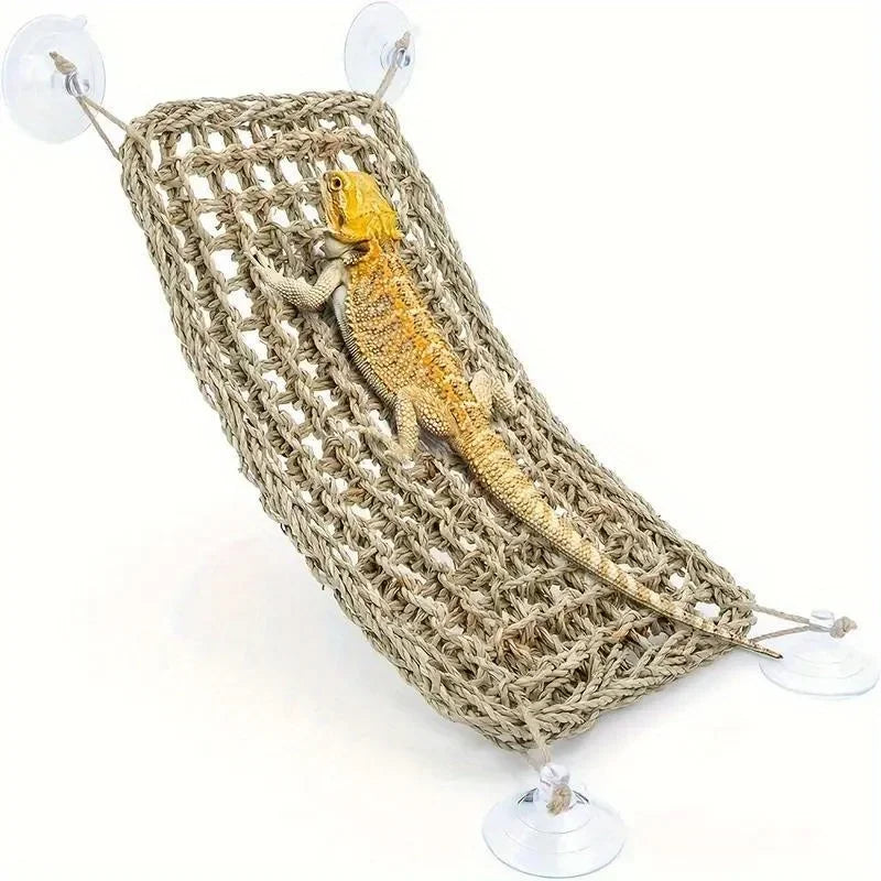 A small yellow lizard is resting inside a woven natural fiber hammock lounger.