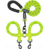 A bright lime green double dog leash with black handles and shock absorbing bungee.