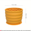 An orange silicone slow feeder dog bowl with concentric ridges.