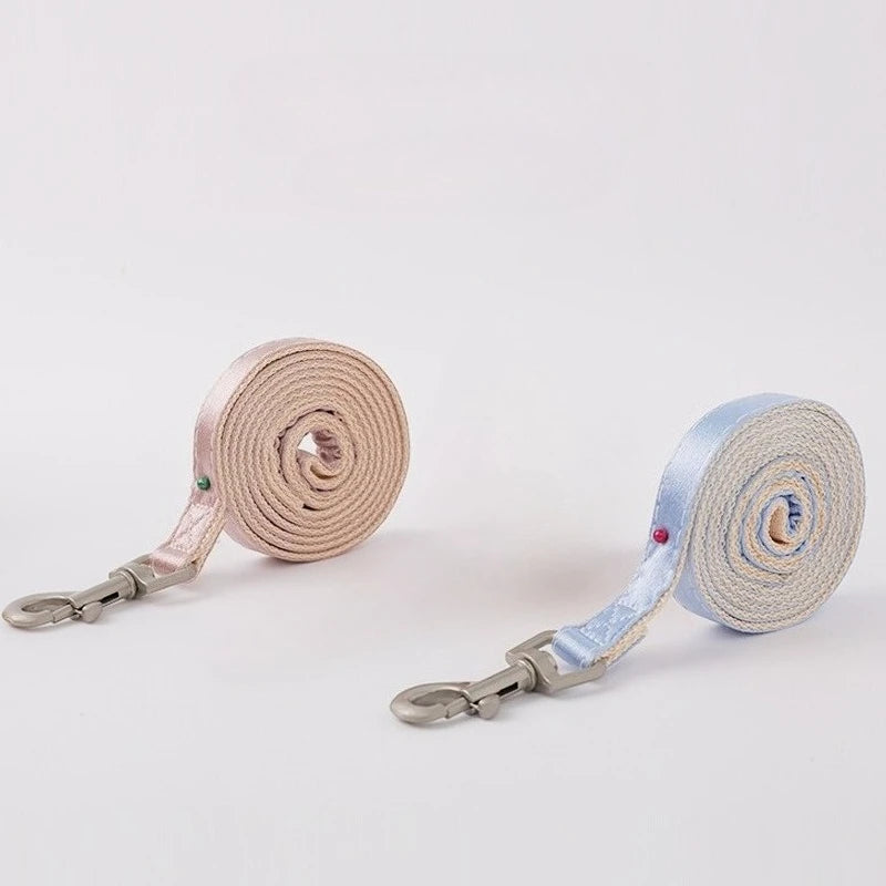 A set of light pink and light blue adjustable bowknot cat harness and leash with metal clasps