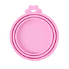 Pink reusable silicone pet food can lid with a spoon.