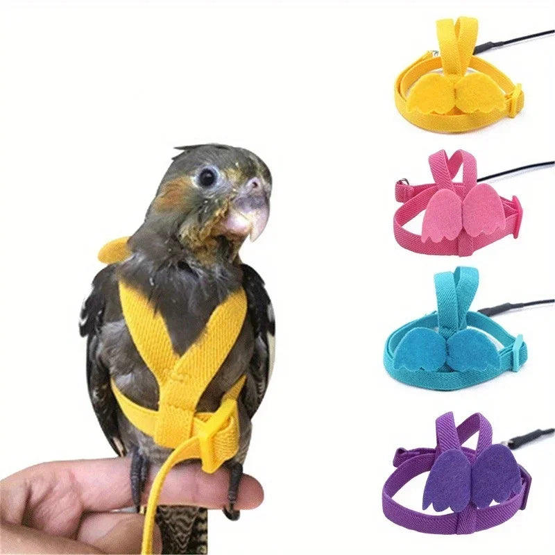 A hand holds an Ultra-Light Parrot Flying Harness in yellow, pink, teal, and purple colors.