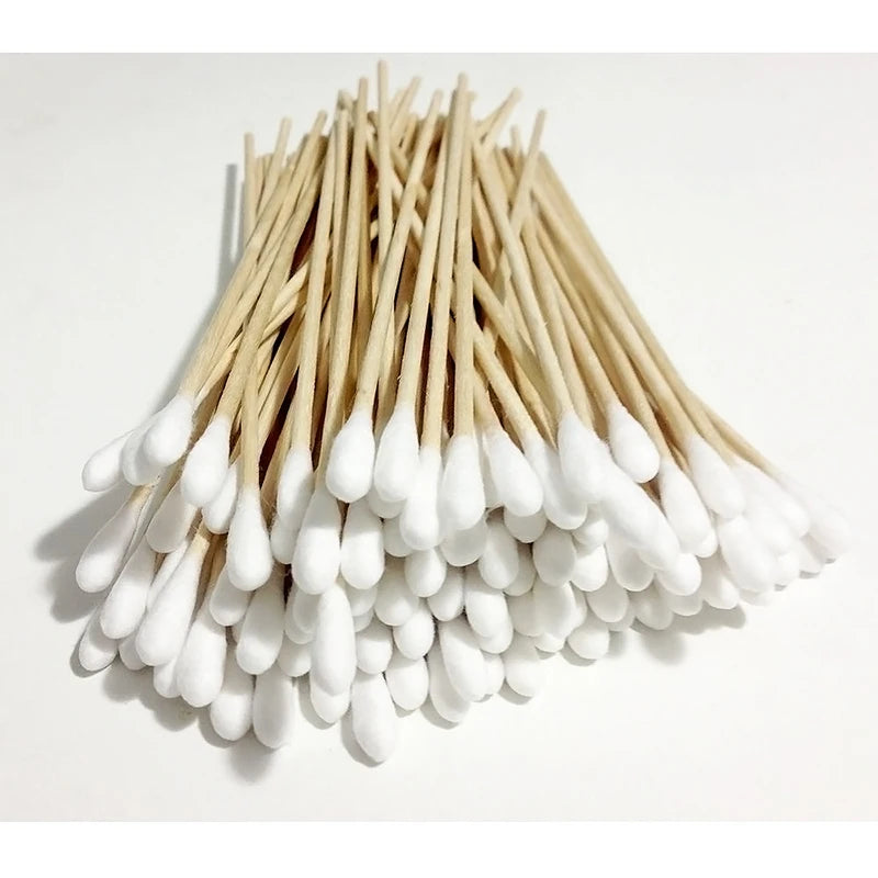 A bundle of white cotton swabs with light brown shafts arranged in a conical shape.
