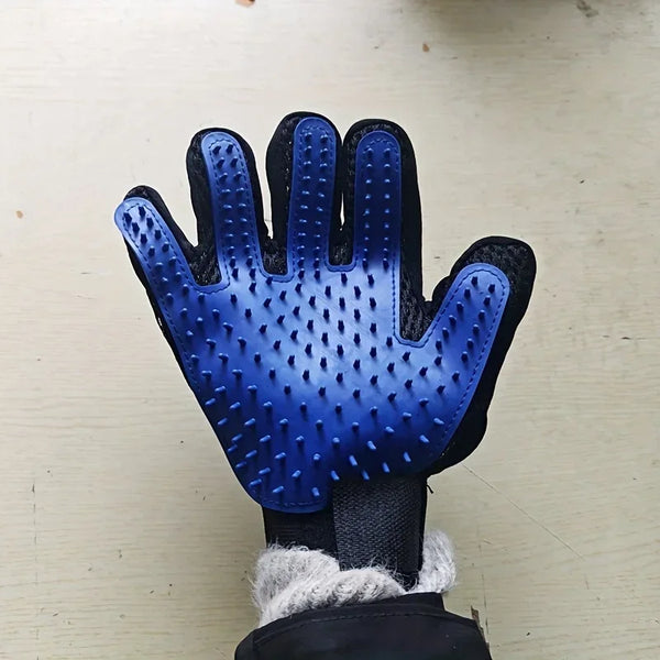 A close-up of a royal blue pet grooming glove with a textured brush for dogs and cats.