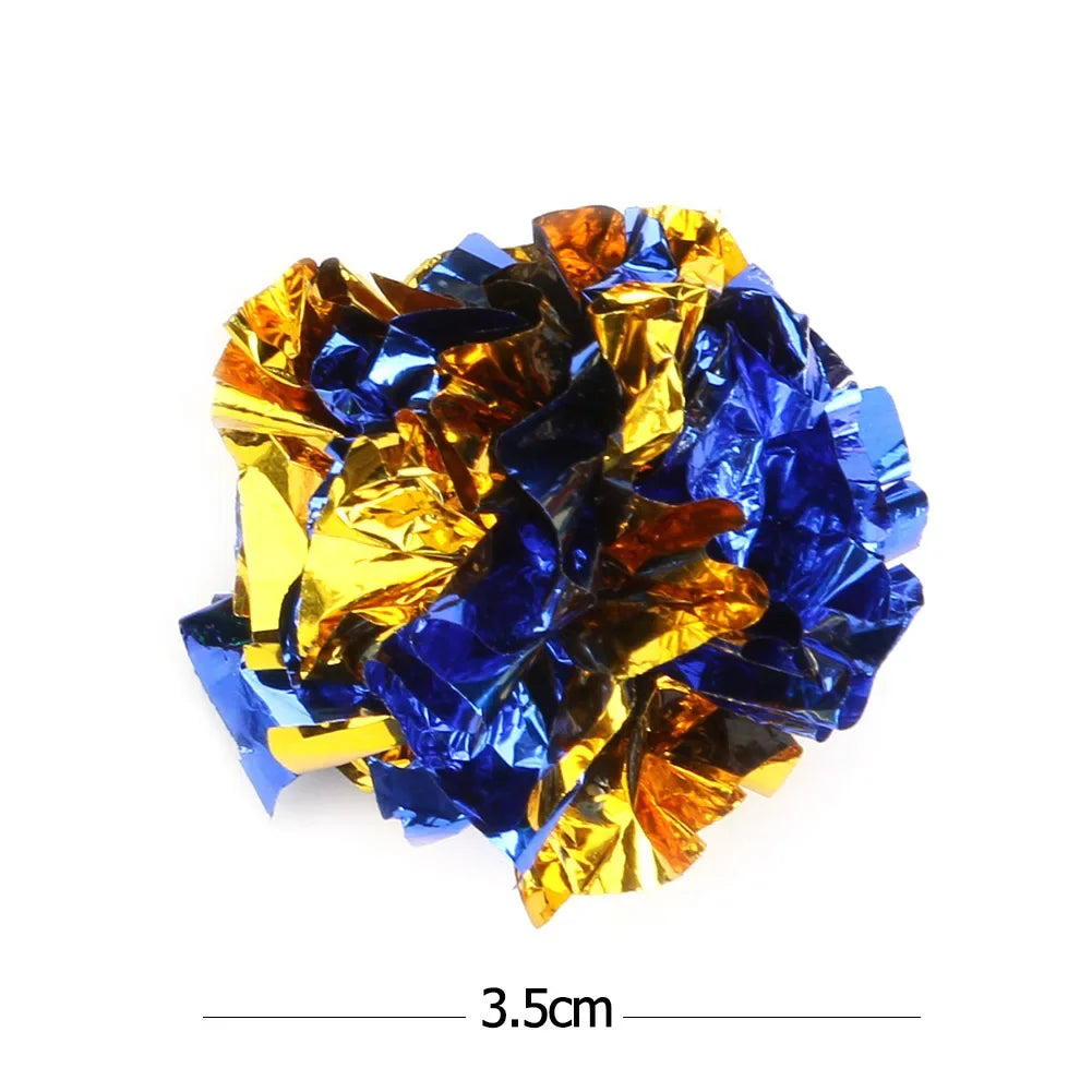A ball of colorful crinkle toys made of shiny gold and blue crinkled material.