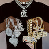 A close-up of a person wearing an iced out letter and animal pendant Cuban link chain necklace against a black shirt.
