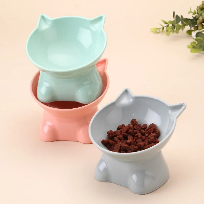 A light mint green ergonomic tilted cat feeding bowl set with a matching base.