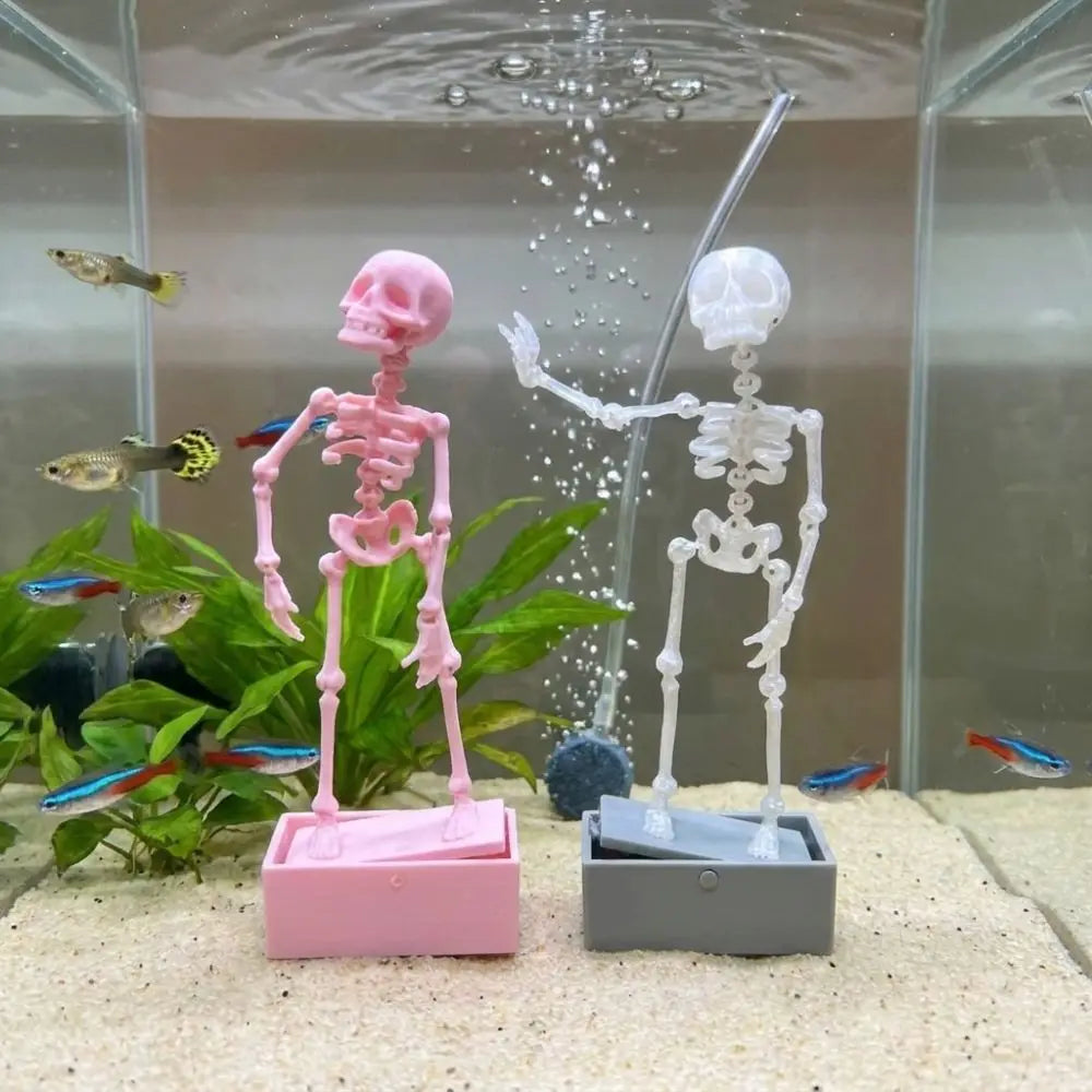 A pink skeleton and a white skeleton are visible in an aquarium with water splashing.