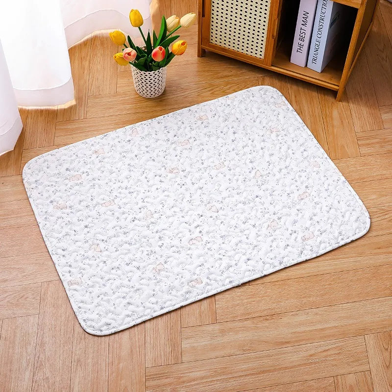 A white soft cotton pet cage mat with a non-slip base placed on a light wood floor.