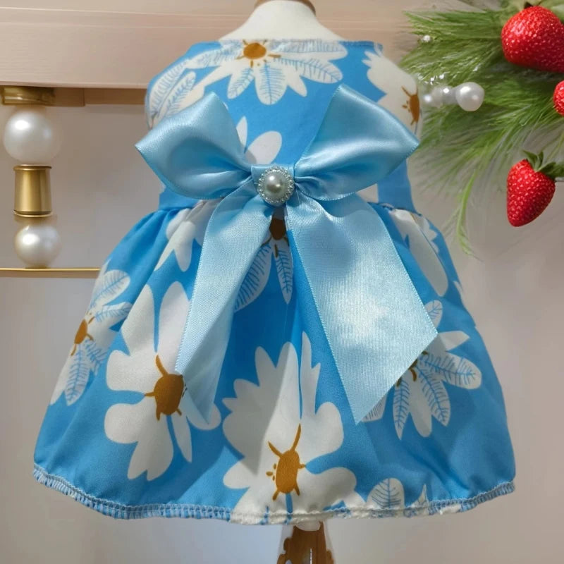 Light blue and white floral dog dress with a satin bow displayed on a mannequin.