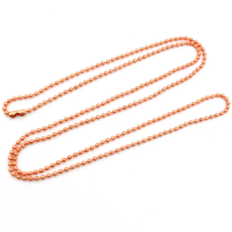 A set of ball necklaces with a gold and silver plated finish displayed on a white background.