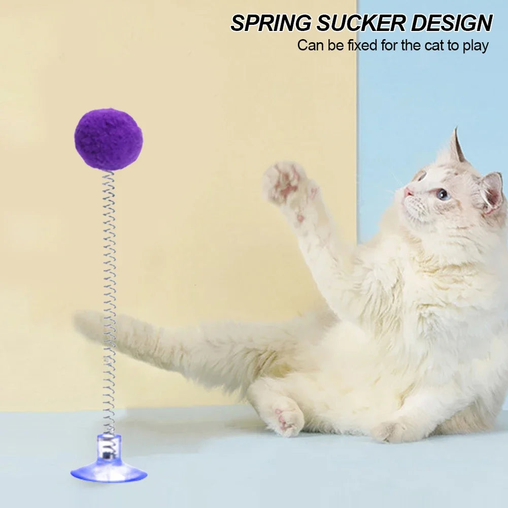 A fluffy purple spring cat toy with a suction cup is shown next to a white cat.