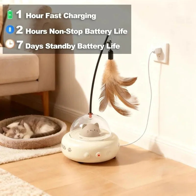 A white interactive UFO cat teaser wand with feathers and a bell resting on a wooden table.