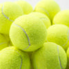 A close-up view of six neon yellow tennis balls with white stitching.