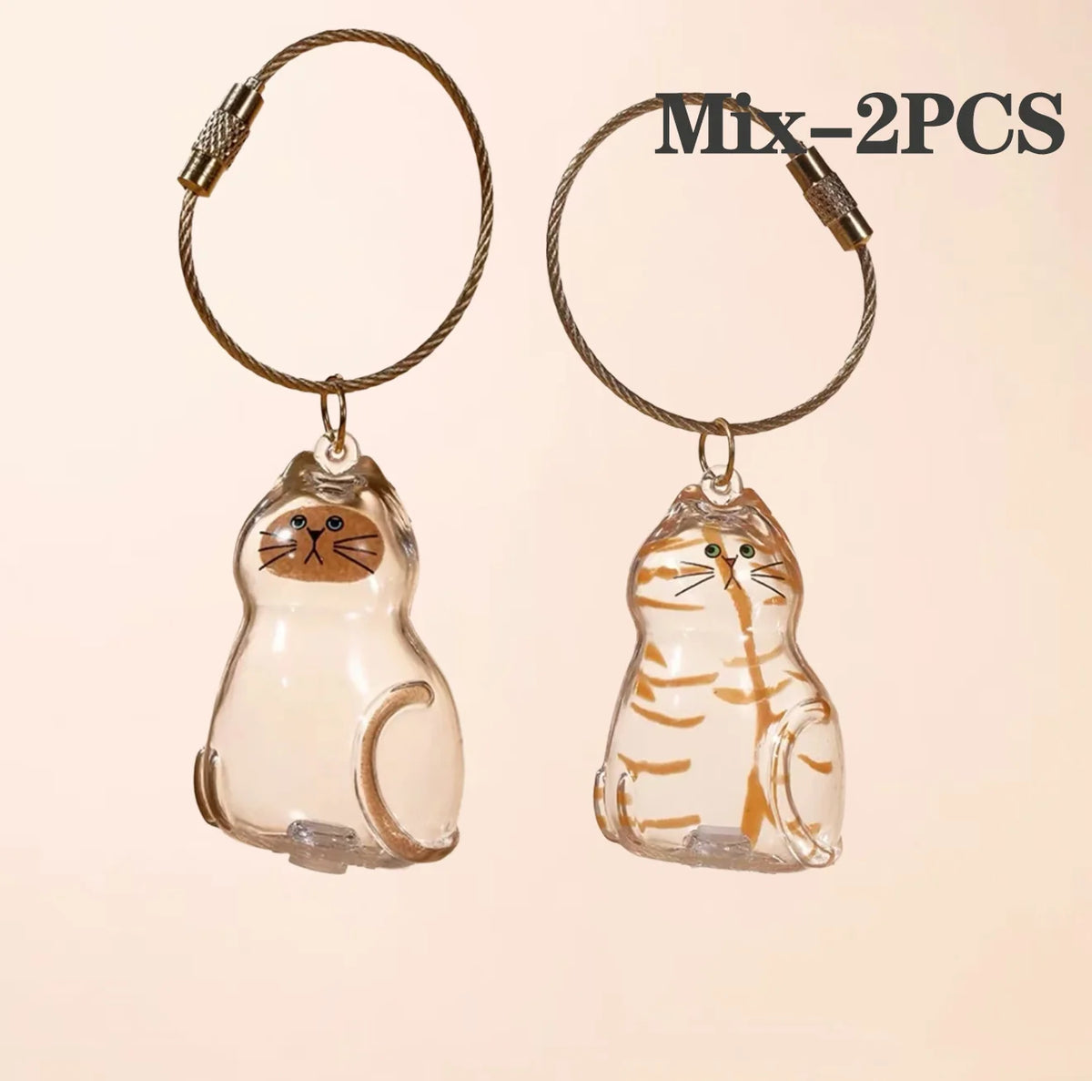 Two glass pendants shaped like cats with gold wire loops for pet hair keepsakes