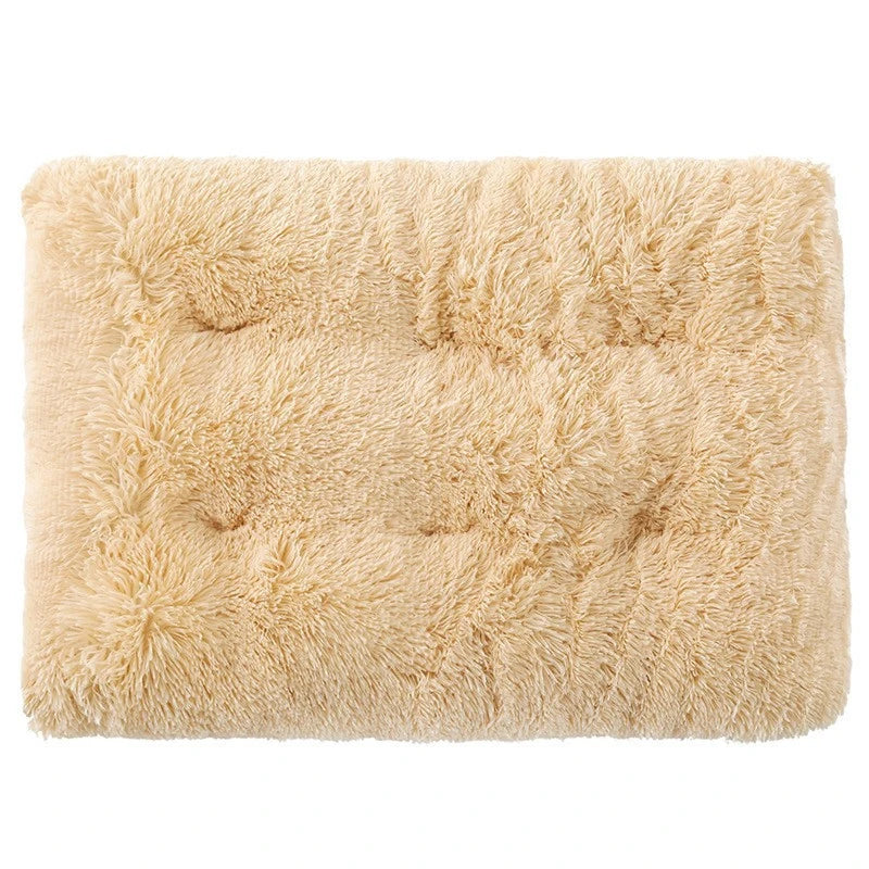 A square, light beige plush pet bed mat with a fluffy texture and non-slip base.