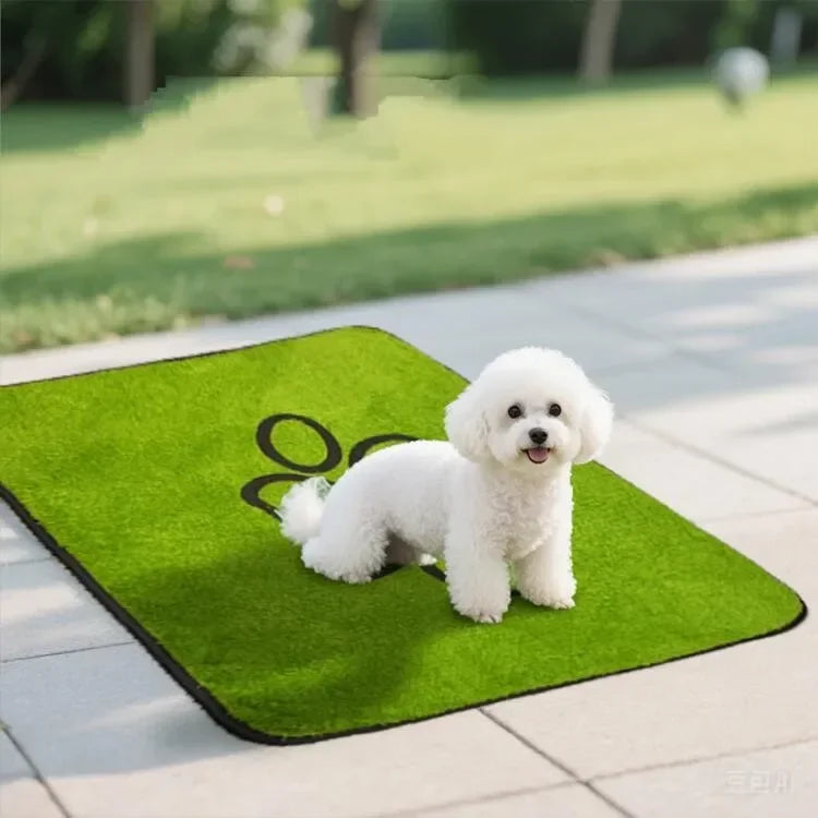 A fluffy white dog lies on a bright green pet grass mat outdoors.