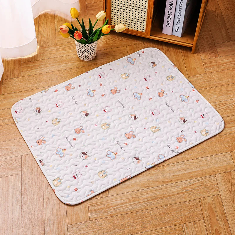 A white soft cotton pet cage mat with a non-slip base placed on a wooden floor next to a potted plant.