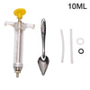 A clear plastic syringe with a yellow plunger and a metal feeding spoon attached, used for parrot feeding.