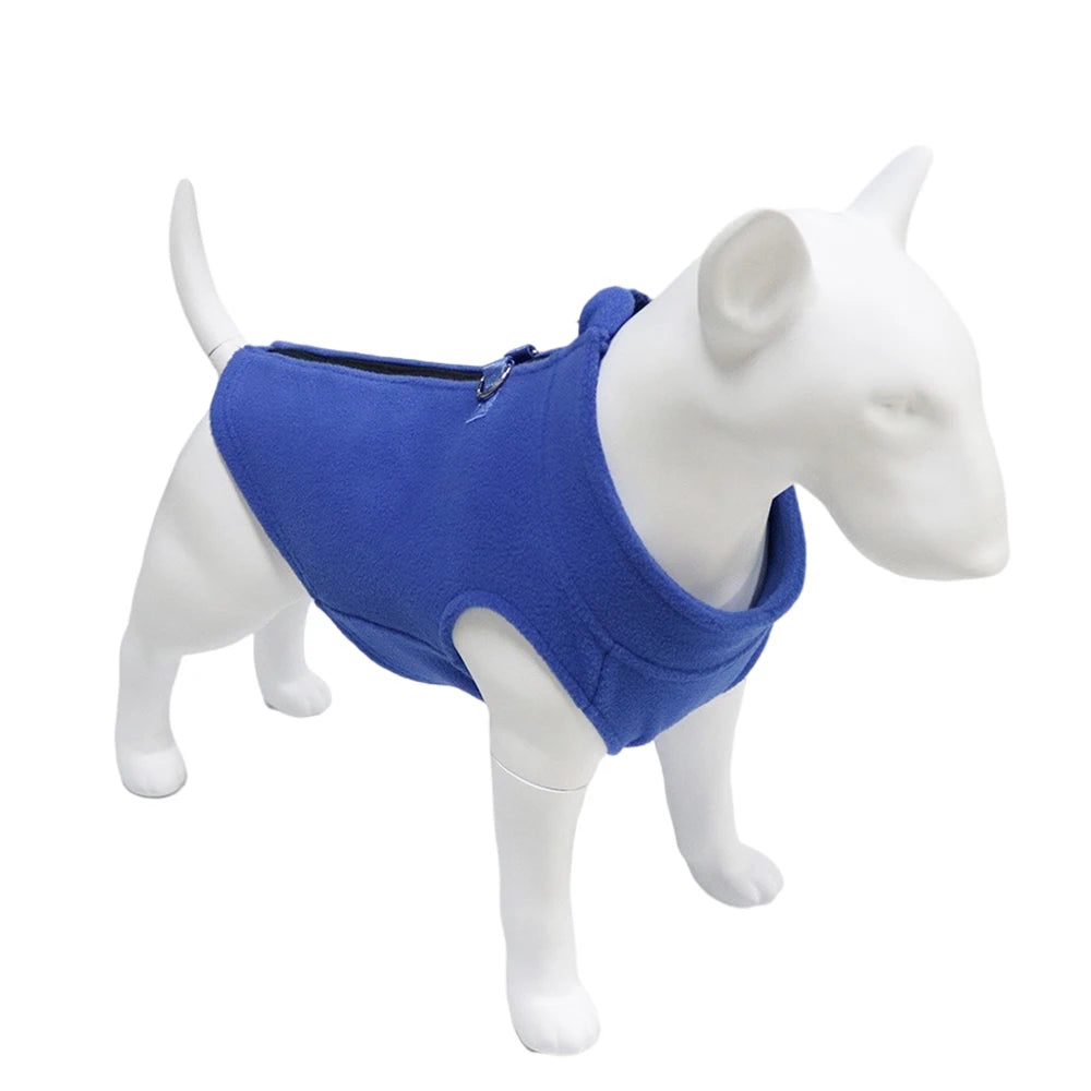 A white dog model wearing a royal blue soft fleece vest.
