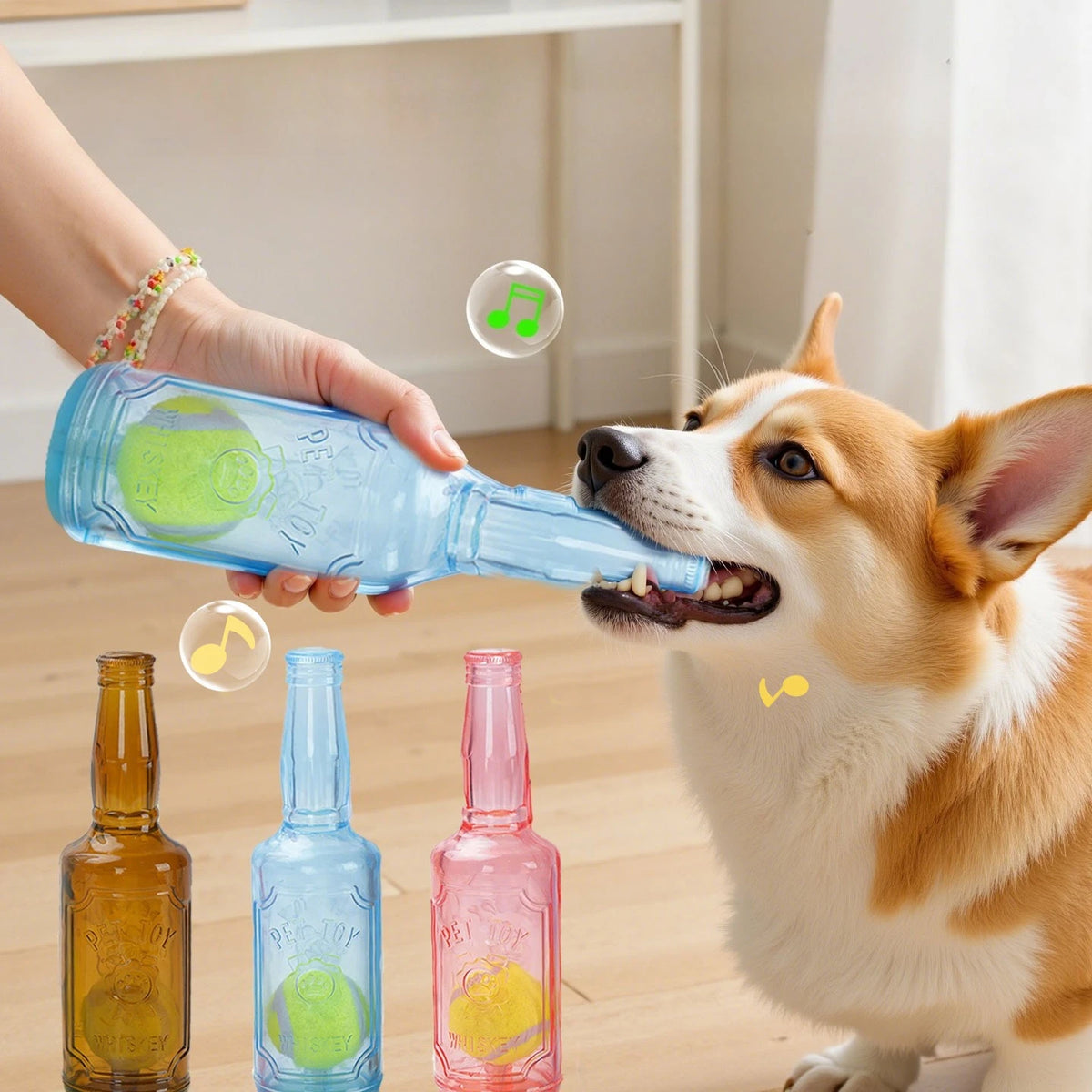 A person is holding a blue beer bottle, which is being used as a chew toy for a dog.
