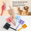 A collection of various colored metal pet grooming tools including slicker brushes and pin brushes.