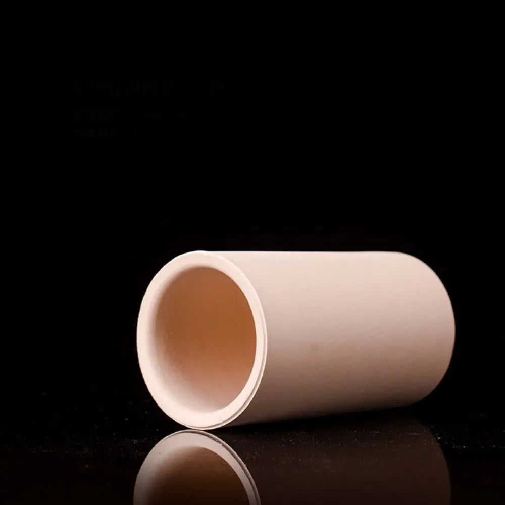 A smooth, cylindrical ceramic aquarium shrimp hideaway cave in a pale pink color.