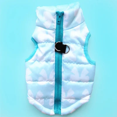 A white quilted dog coat with light blue trim and a black snap closure.