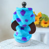 Blue and purple plush fleece pet overalls for dogs and cats displayed on a stand.