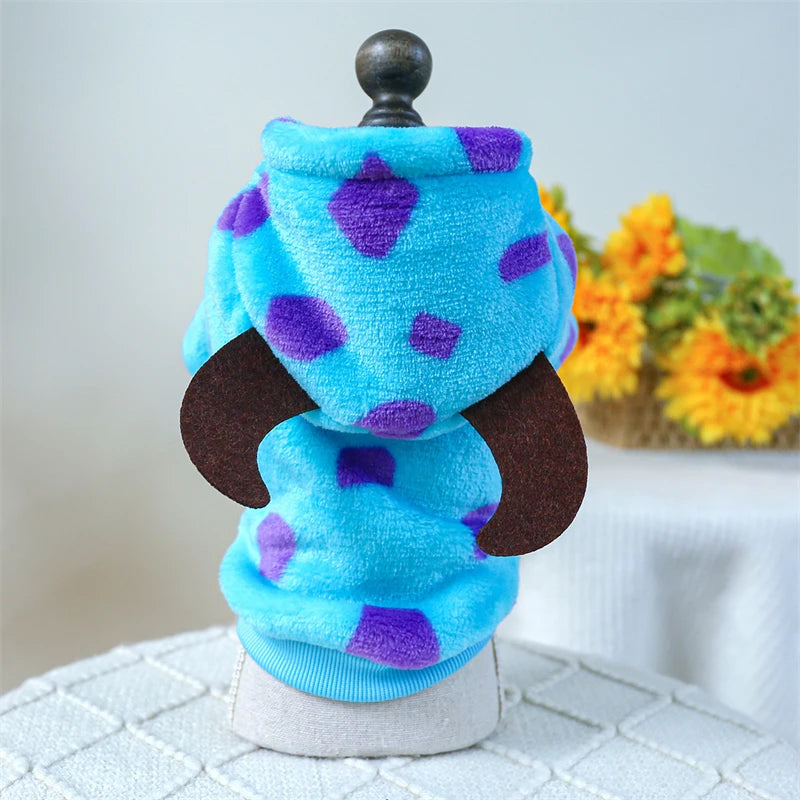 Blue and purple plush fleece pet overalls for dogs and cats displayed on a stand.