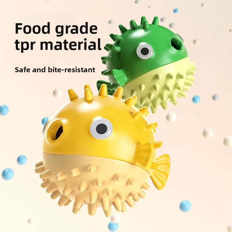 A yellow and green tpr material fish-shaped treat dispenser for pets.
