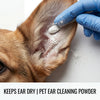 A blue gloved hand applies pet ear cleaning powder to a dog's ear.