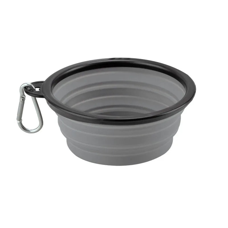 A dark gray collapsible silicone pet travel bowl with a handle.