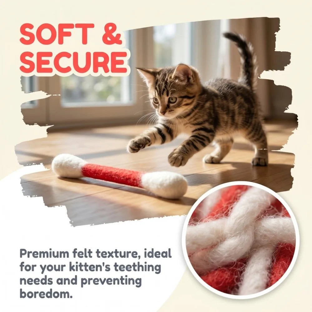 A tabby kitten plays with a red and white felt cat toy on a wooden floor.