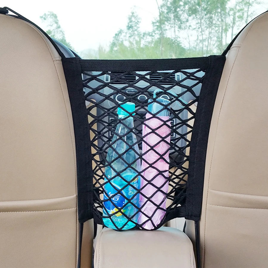 A black mesh storage bag for car dogs is visible in a vehicle seat, holding two plastic water bottles.