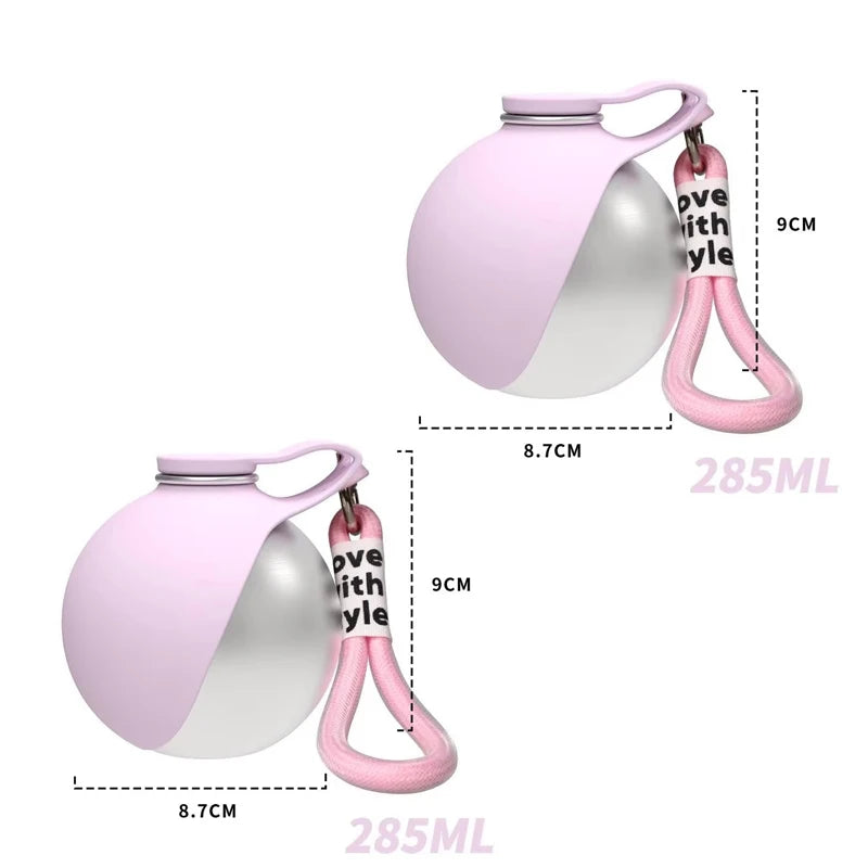 A pink portable stainless steel dog water bottle with a built-in bowl and carrying loop.