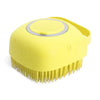 A yellow silicone pet shampoo brush and grooming comb with a rounded head and bristled teeth.