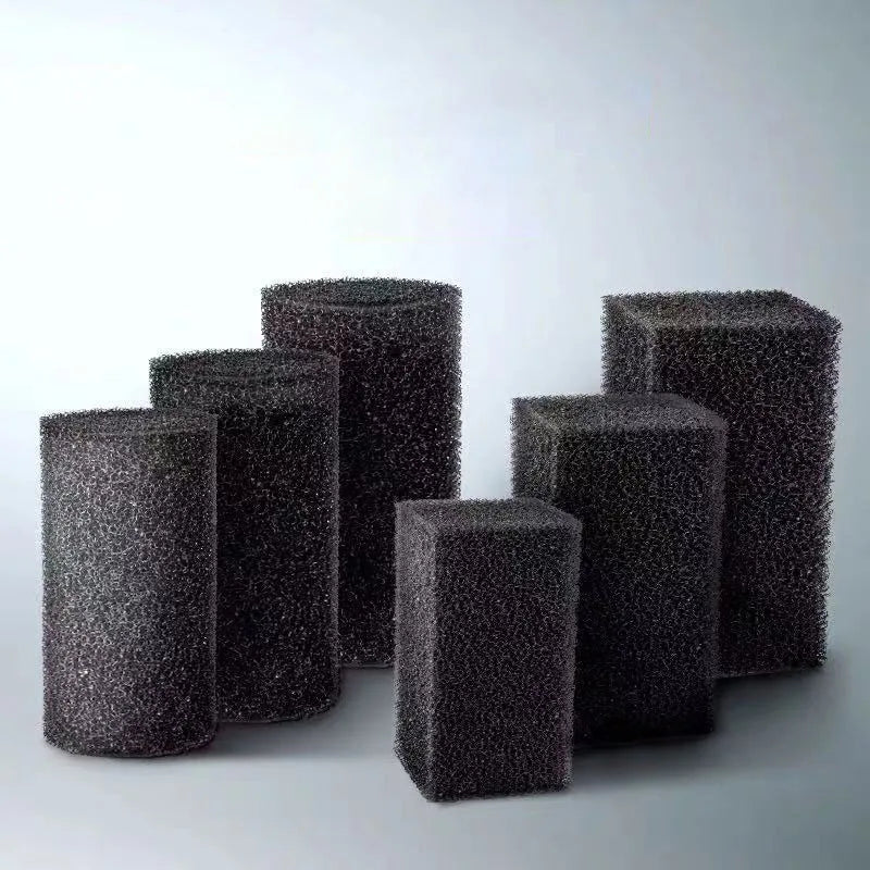 A collection of black high-density bio sponge filter media cubes and cylindrical pieces.