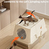 A brown cat is using a fully enclosed stainless steel litter box designed to conform to the cat's jumping nature.