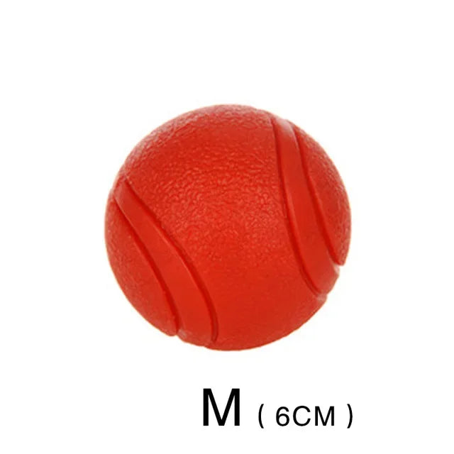 A bright red rubber dog ball, size M (6cm), shown from a top view.