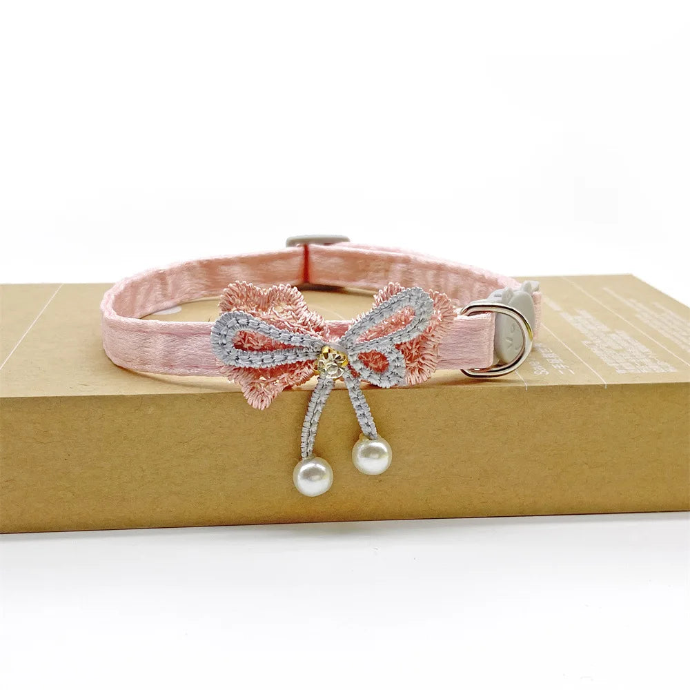 Pink lace flower cat collar with a pearl bell hanging from the adjustable soft necklace