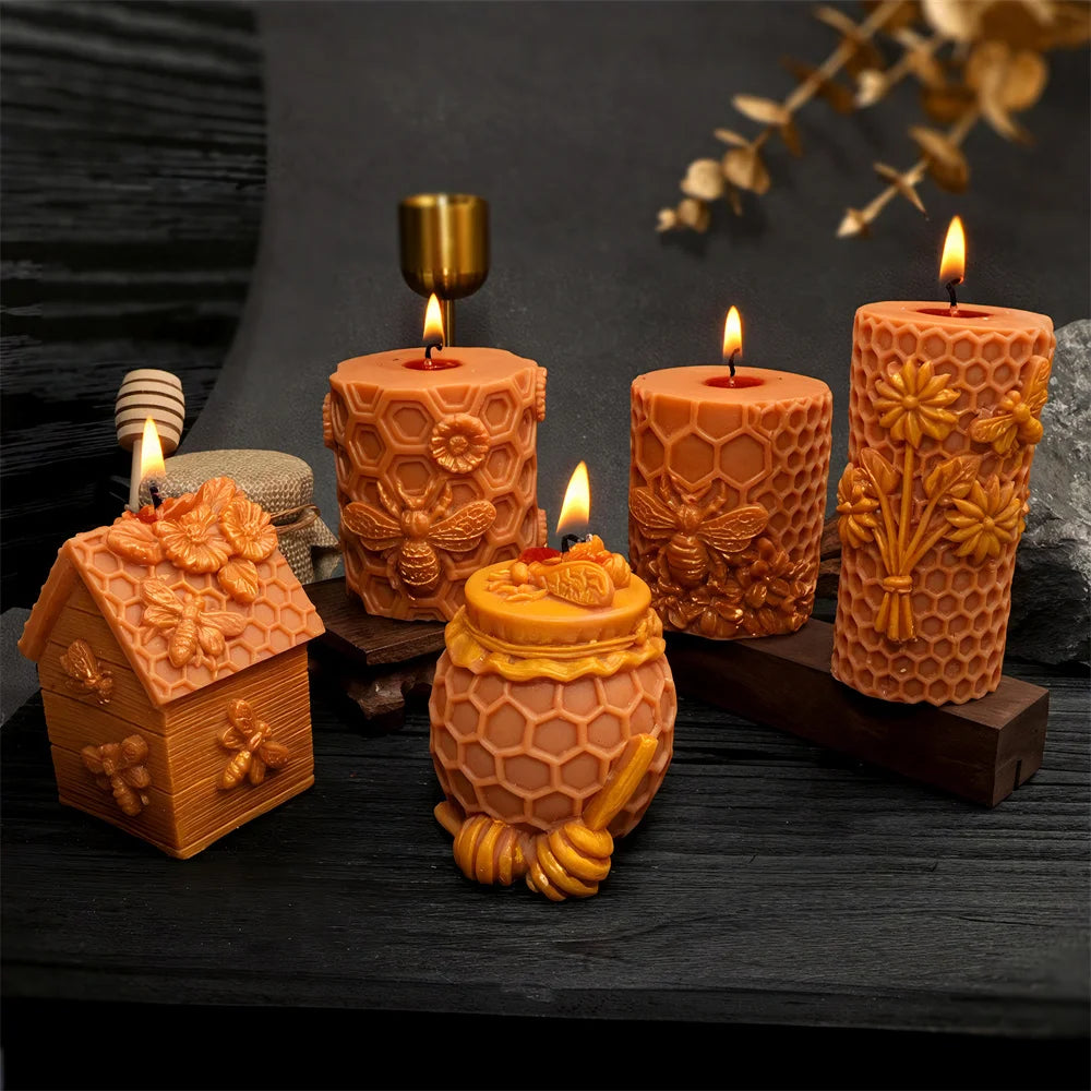 Honeycomb silicone mold for candles and crafts featuring various sizes of orange wax candles and a small honeycomb-shaped obj